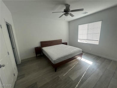 Bedroom with wood finished floors, baseboards, and