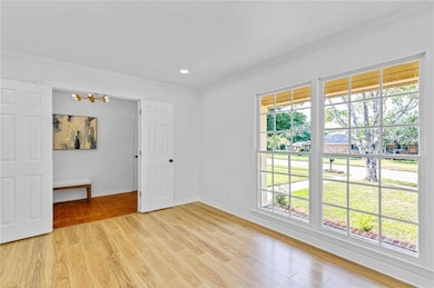 Unfurnished bedroom with crown molding, light wood finished floors, and recessed lighting
