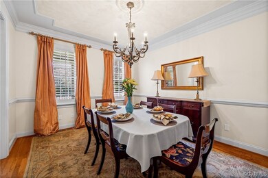Dining area with a chandelier, light hardwood / wo