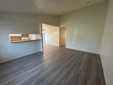 Unfurnished living room with lofted ceiling, a ch