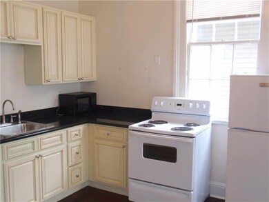 The kitchen has graite counters, stove, and refrig