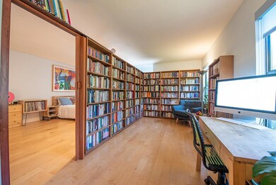 Office featuring bookshelves and light wood-style