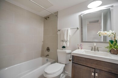 Full bathroom featuring toilet, tiled shower / bat