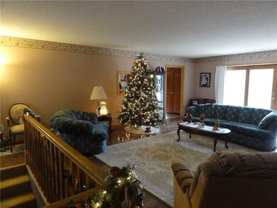 Living room with stairway to lower...