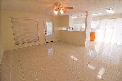 Spare room featuring a ceiling fan, light tile pa