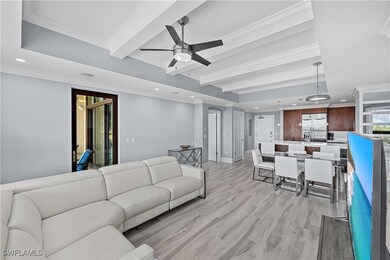 Living room with ceiling fan, beam ceiling, crown molding, and light hardwood / wood-style flooring