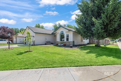 Ranch-style house featuring a front lawn, driveway, garage and massive shop