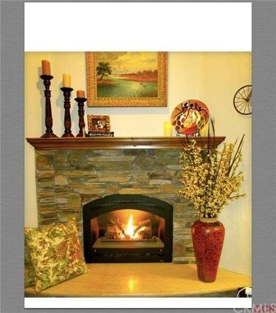 Stone surround gas log fireplace.