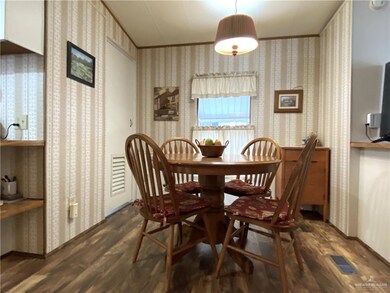 Dining space with dark hardwood / wood-style floors
