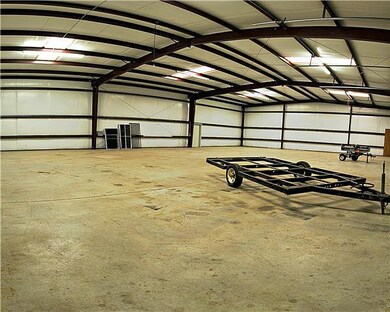 Insulated walls all around, skylights to make it light in the day without the electric lights. Good cement floor thru out. Secure lockable doors. Separate electric meter. Could be used as business.