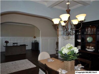 VIEW FROM DINING AREA INTO FOYER WITH A LOOK AT THE LIVING ROOM...ALSO THE PERFECT SPACE FOR AN OFFICE AND STUDY