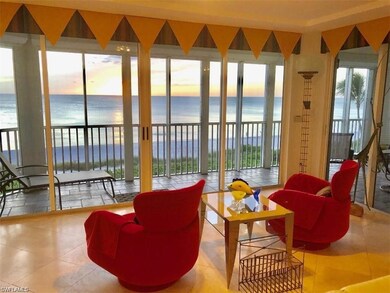 Sunroom / solarium featuring a view of the beach a