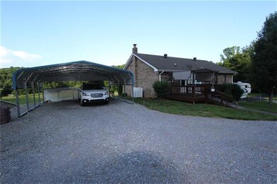 Back view of home & carport. Back deck with perman