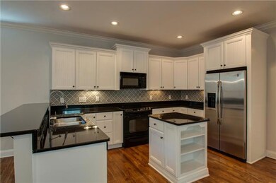 Nimble granite kitchen has great work space and under cabinet lighting. Tile backsplash repeats the design in the butler pantry. With an open concept floor plan, the cook doesn’t miss out on any of the action.    Breakfast, anyone? This will be a fav