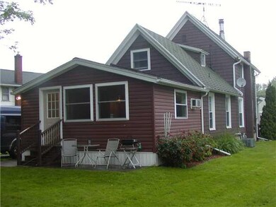 Exterior Back Back view of home shows family room 