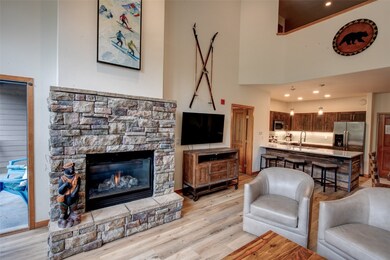 Living room featuring a fireplace and light wood-t