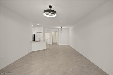 Unfurnished living room with a sink, visible vents