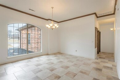 Dining room with chandelier and ornamental molding