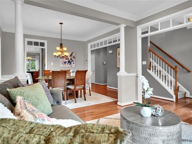 Living room featuring ornamental molding, hardwood