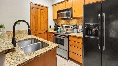 Kitchen featuring light tile patterned flooring, a