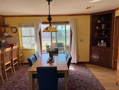 Dining area with light wood finished floors, visib