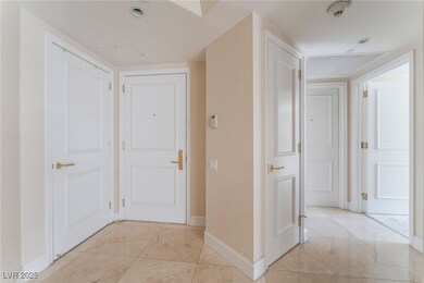 Hallway with baseboards and light marble finish fl