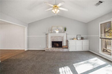 Unfurnished living room with ceiling fan, a firepl
