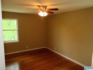 Bedroom 1 is good size with shining wood floors.