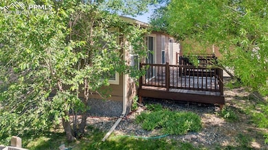 Yard has large deck with sliding doors to the living room and the Primary bedroom