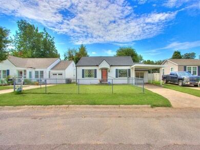 Ranch-style home with a front lawn and a carport