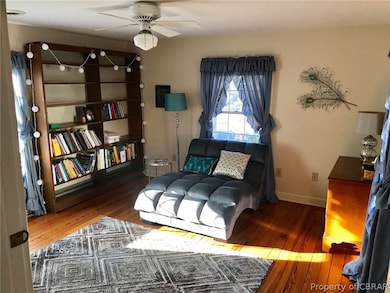Bright sunny bedroom upstairs with wood floors.