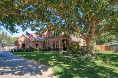 Majestic oak adorns the front yard providing welco