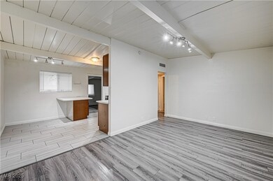 Unfurnished living room featuring track lighting,