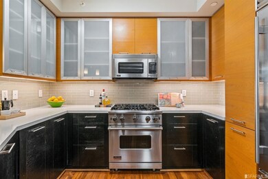 Kitchen, Viking gas range, SubZero Refrigerator, glass tile backsplash and Quartz countertops.