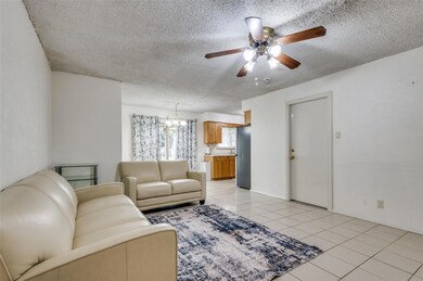 Living room featuring ceiling fan with notable cha