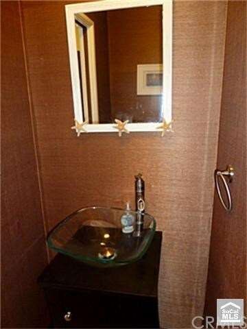 Main floor half bath with decorator wallpaper and 