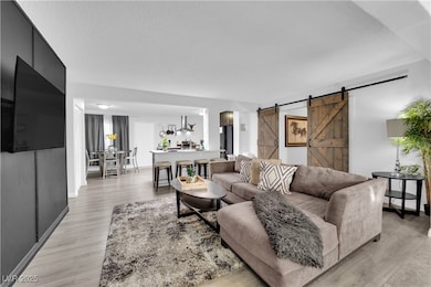 Living room featuring light wood-type flooring, ba