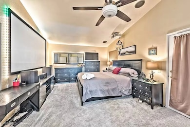 Carpeted bedroom featuring vaulted ceiling and cei