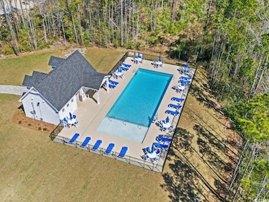 Community pool featuring a patio area, fence, and 