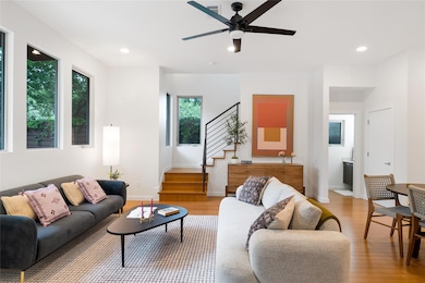 Living area featuring stairway, recessed lighting