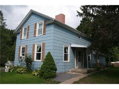 Exterior Front. An entrance sidewalk leads to an e
