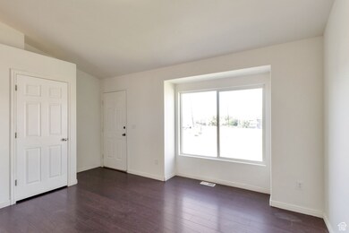Unfurnished bedroom with dark wood-style floors