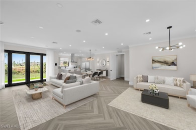Living room with a chandelier, visible vents, and