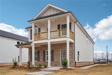 View of front facade with covered porch, brick sid