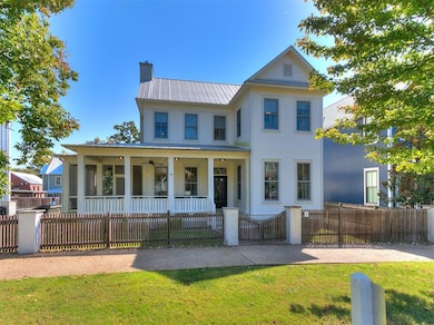 View of front facade featuring a front yard and a porch