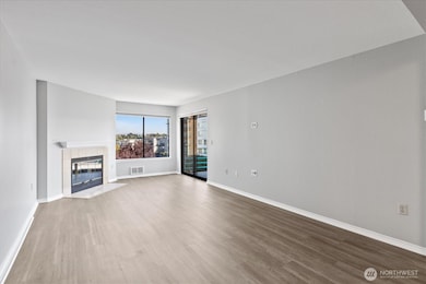 Living Room w/ cozy fireplace and glass to covered patio.