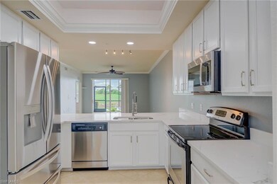 Kitchen featuring appliances with stainless steel finishes, ornamental molding, a peninsula, and white cabinetry