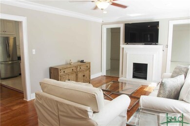 Living room leads to dining room and kitchen.