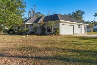 Side of the house featuring two garage doors