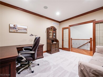 Office with ornamental molding and light colored carpet